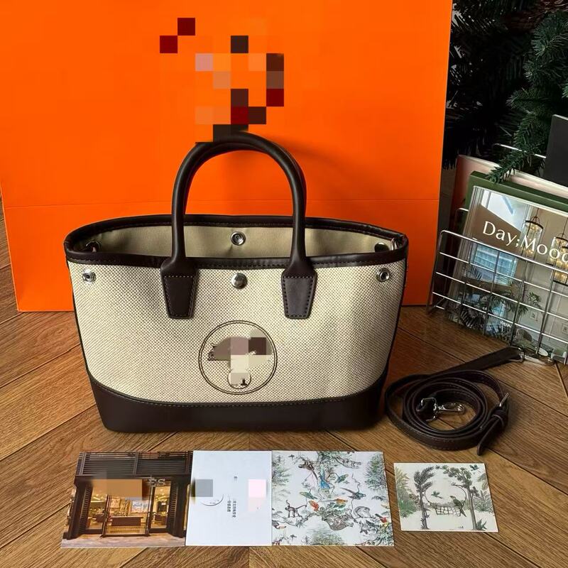 Transformed linen canvas and leather patchwork tote bag with carriage logo, floral and ingot motifs, niche minimalist shoulder and crossbody bag