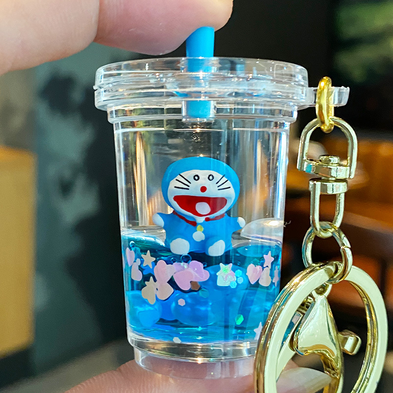 Doraemon Quicksand llavero femenino lindo estudiante niños mochila colgante coche llavero pareja pequeña joyería