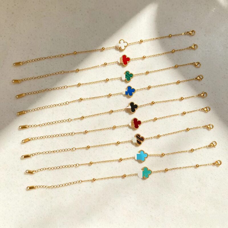 New titanium steel four-leaf clover bracelet for women, featuring a delicate gold bead design, adjustable size, and available in multiple colors. Wholesale jewelry New titanium steel four-leaf clover bracelet for women, featuring a delicate gold bead design, adjustable size, and available in multiple colors. Wholesale jewelry