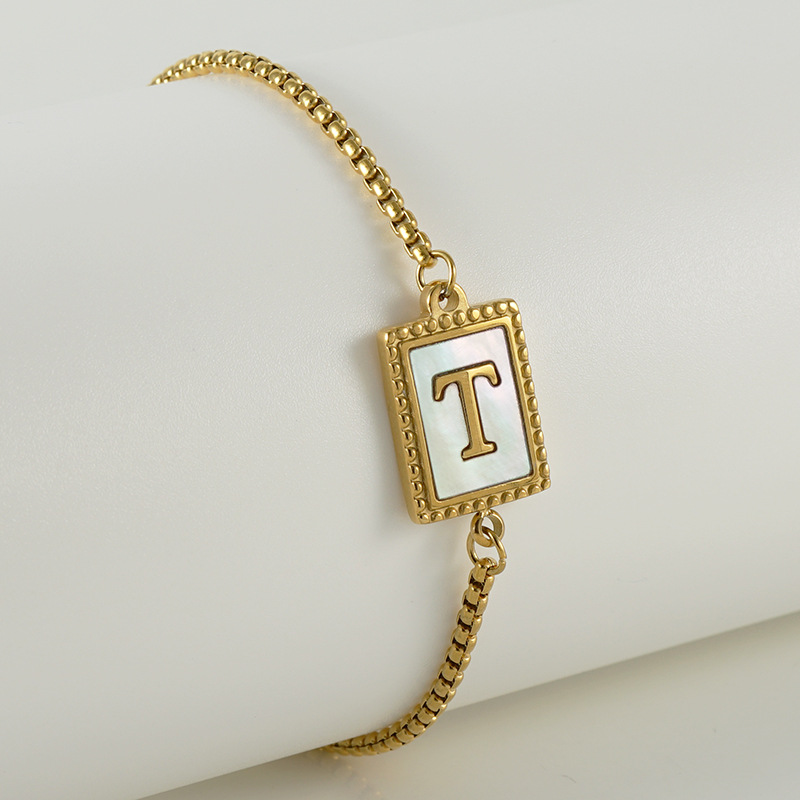 Nuevo europeo y americano transfronterizo de acero inoxidable 26 letras inglesas Shell pulsera personalidad todo partido titanio acero 18K cremallera