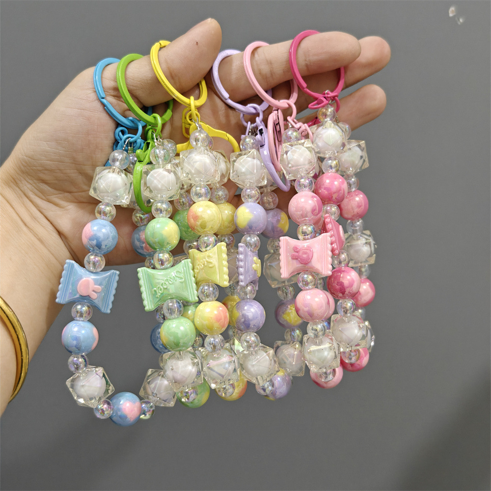 Xiaohongshu mismo estilo bicolor colorido cadena de teléfono móvil bolso de cadena de cuentas hecho a mano caja de teléfono colgante llavero al por mayor