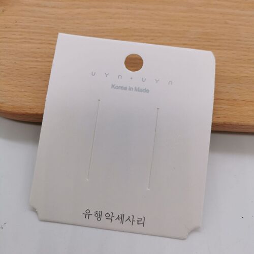 A pack of approximately 100 white hair clip earring ear stud cardboard hair tie necklace packaging card square card tag paper card