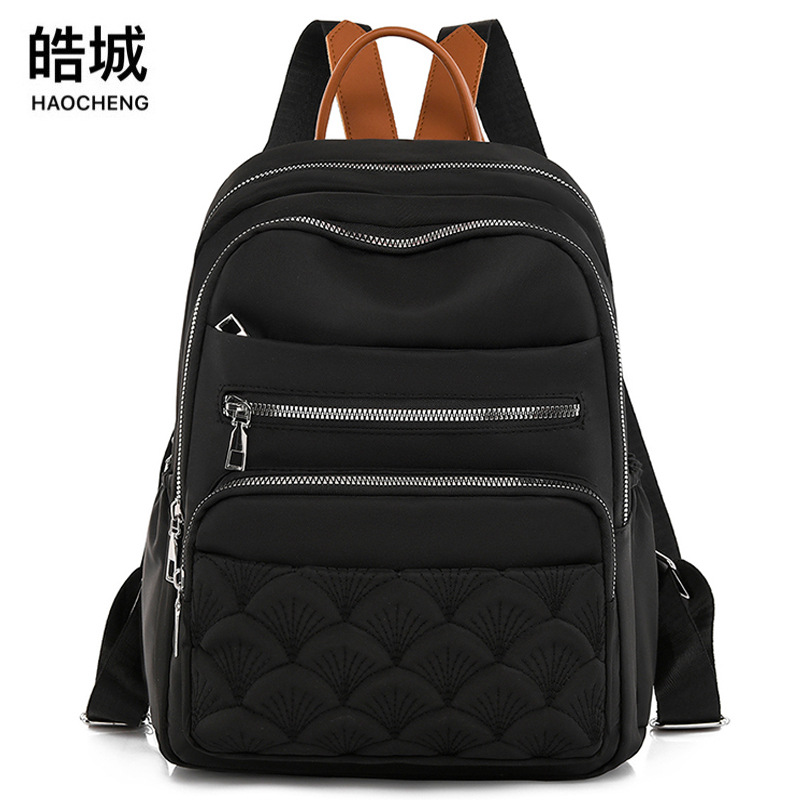 Comercio exterior al por mayor 2023 nueva mochila de tela Oxford para mujer retro casual, bordado de moda, mochila de viaje ligera