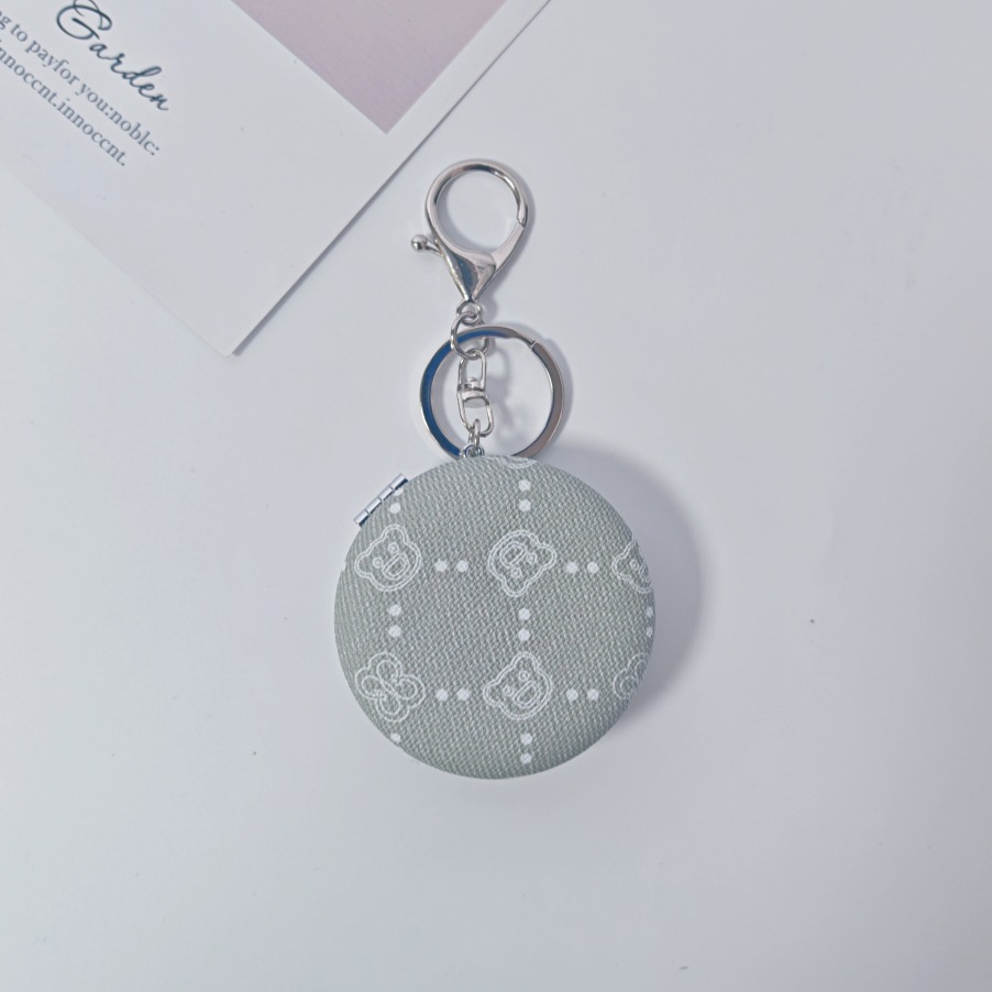 Bolsa de espejo popular en línea colgante de lujo ligero llavero portátil espejo de maquillaje transfronterizo colgante de bolsas de espejo doble cara