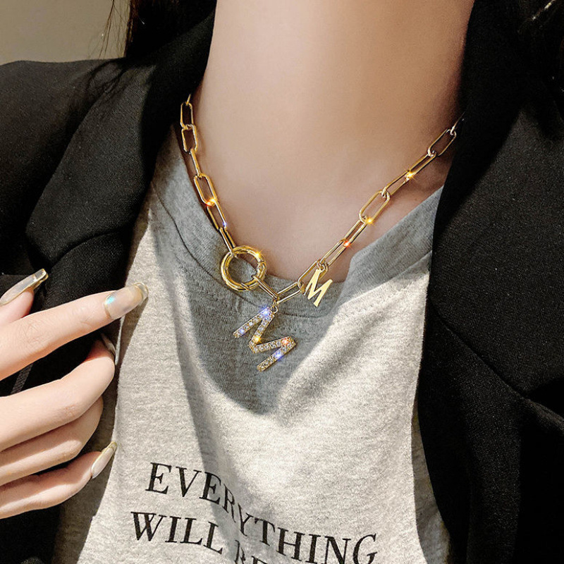 Golden necklace with letters