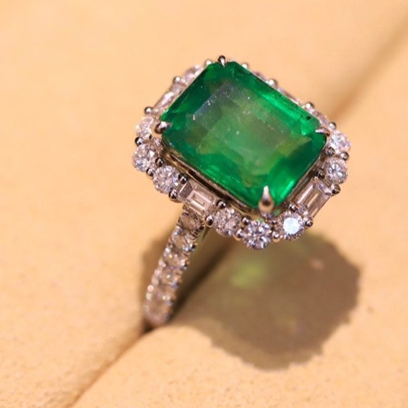 New 18K gold emerald ring. Charming emerald paired with crystal…