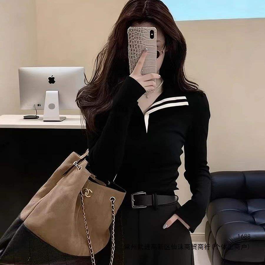 Stylish and sophisticated black striped collared top with contrasting trim, perfect for a chic and sophisticated look. A super popular new style for Autumn/Winter 2026.