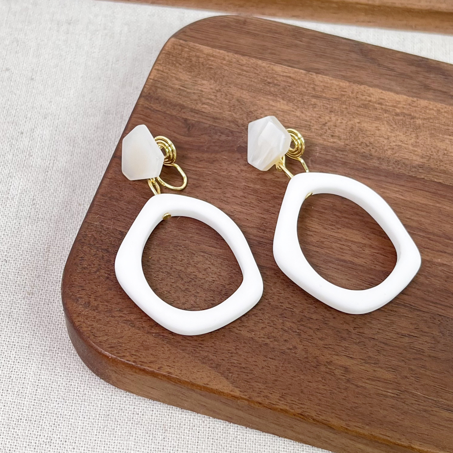 White geometric ear clips
