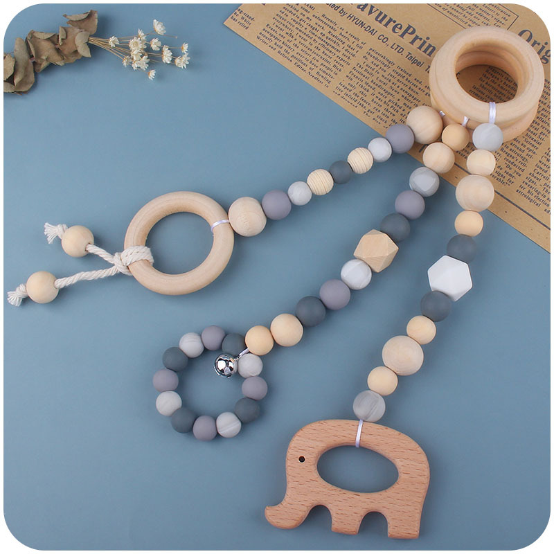 Nuevo Bebé calmante juguetes traje bebé cuentas de silicona haya molares mordedor juguetes pequeña campana Amazon