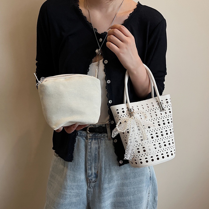 Bolso de cubo de diseño de nicho 2025 nuevo bolso de hombro con agujero hueco bolso de mensajero con lazo de estilo occidental mujer