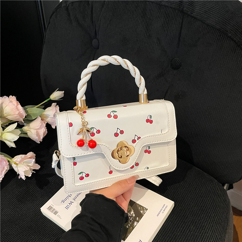 2025 nuevo bolso de mensajero con estampado de cereza lindo bolso cuadrado pequeño portátil girando bolso de niña de diseño de color de contraste fresco
