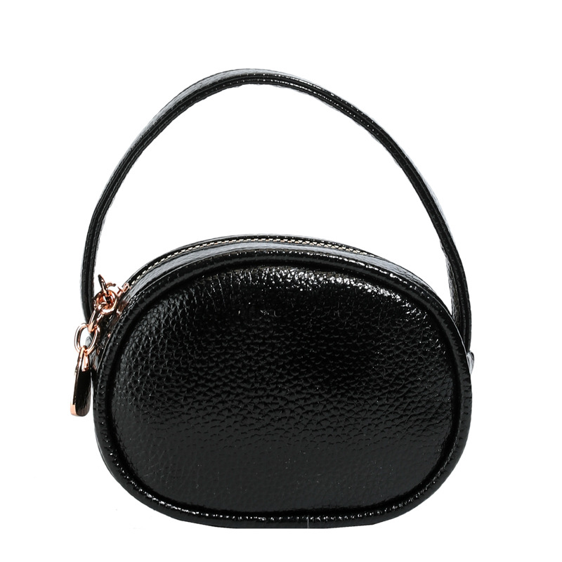 Bolso de mano de niña láser brillante simple color sólido mini bolso de cambio de bebé coreano nuevo bolso infantil transfronterizo