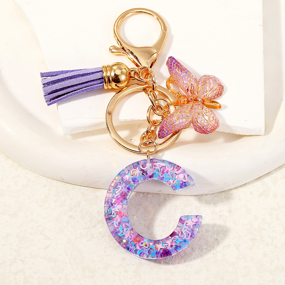 Mayorista transfronterizo mariposa esquinilla iniciales llavero de cristal goteo llavero de letras bolsos colgante