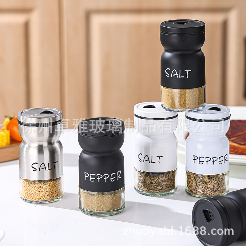 Botella de condimento transfronterizo de pimienta, sal y pimienta Botella de condimento redonda giratoria Combinación en blanco y negro Juego a prueba de humedad Tarro de condimento de vidrio