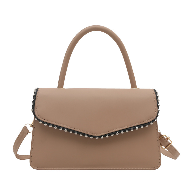Bolso de hombro de aire extranjero para mujeres 2025 primavera nueva moda coreana portátil de color sólido simple bolso de tendencia