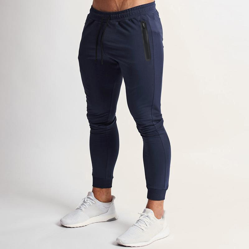 2023 Estación independiente transfronteriza europea y americana primavera y verano nueva versión ligera de color puro pantalones de fitness pantalones deportivos elásticos casuales moda masculina