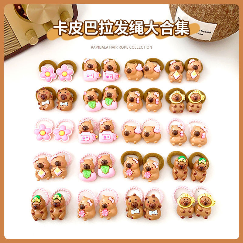 子供のカピバラの小さい皮の筋の小さい女の子は髪の輪を刺して髪のひもの女の子の高弾力の髪のひもを傷つけません。|undefined