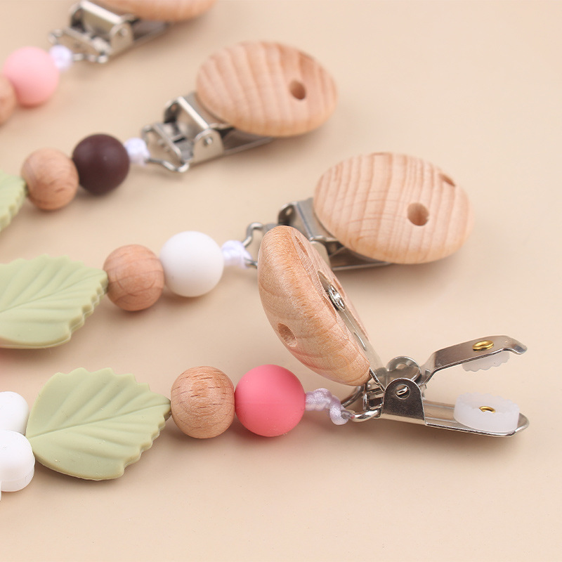 Nuevos productos para bebés Clip de chupete de haya Creativo bebé Silicona margarita mordida molar cadena de chupete anti-caída