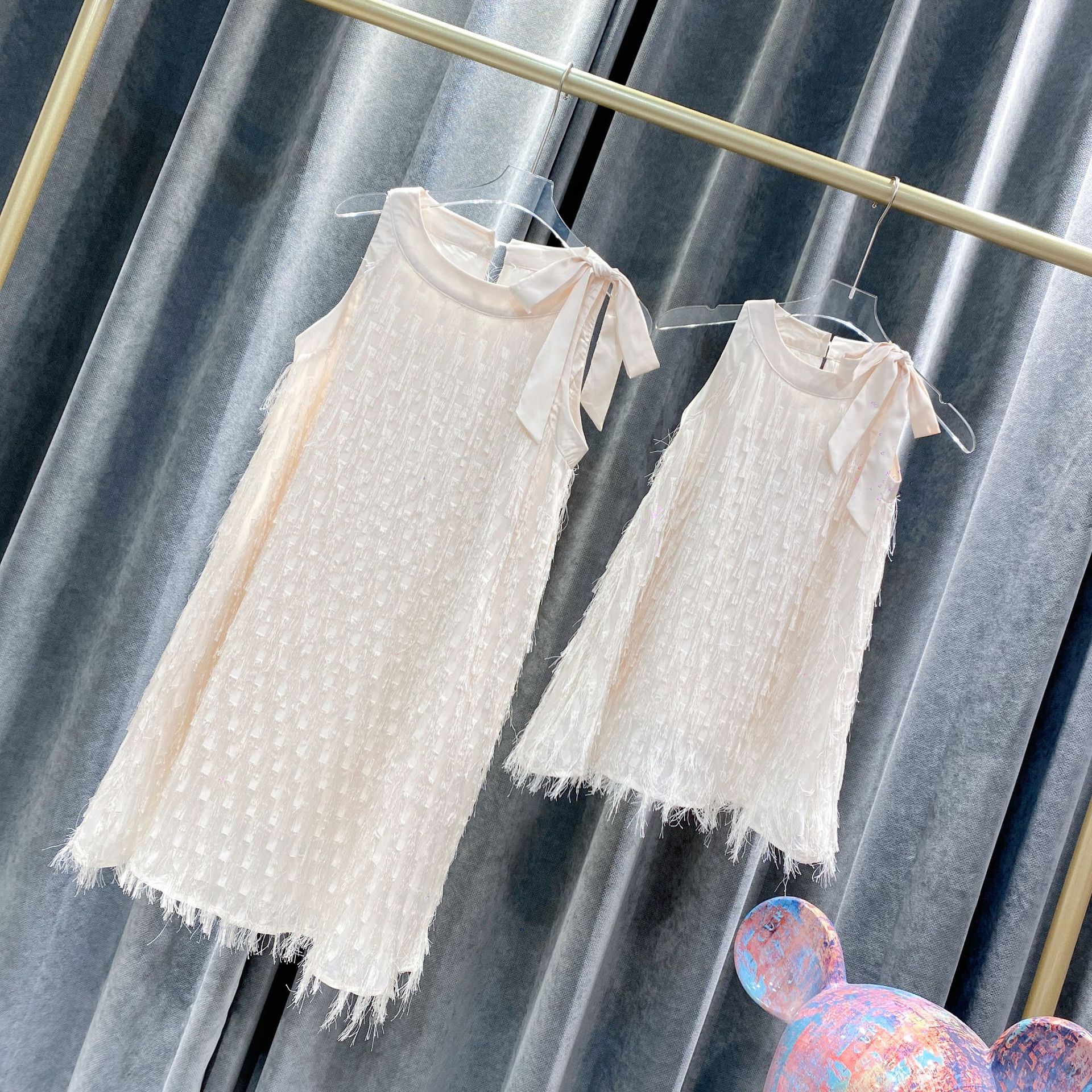 Mommy and daughter wearing matching white dresses for a summer outing