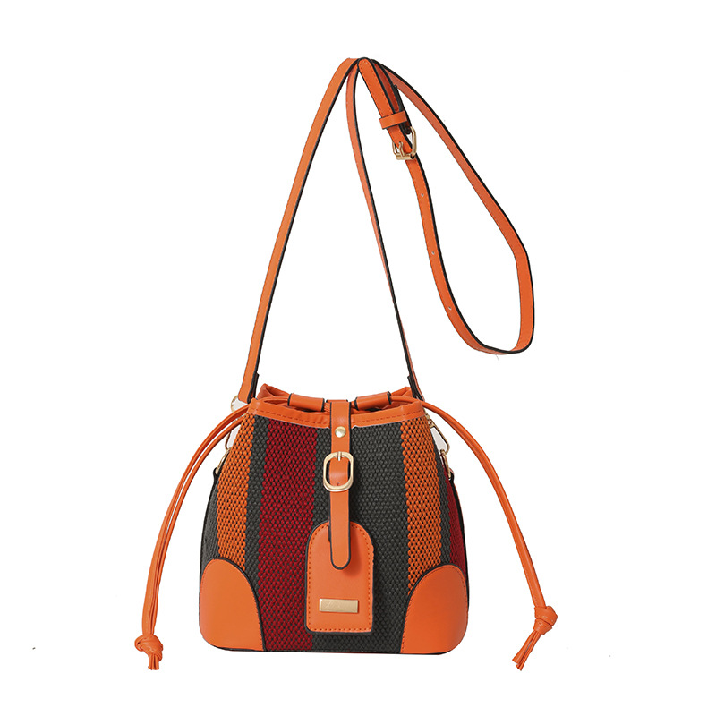 Diseño de nicho de moda bolsa de cubo portátil para mujeres 2023 nueva moda lienzo contraste color rayas hombro bolsa de mensajero