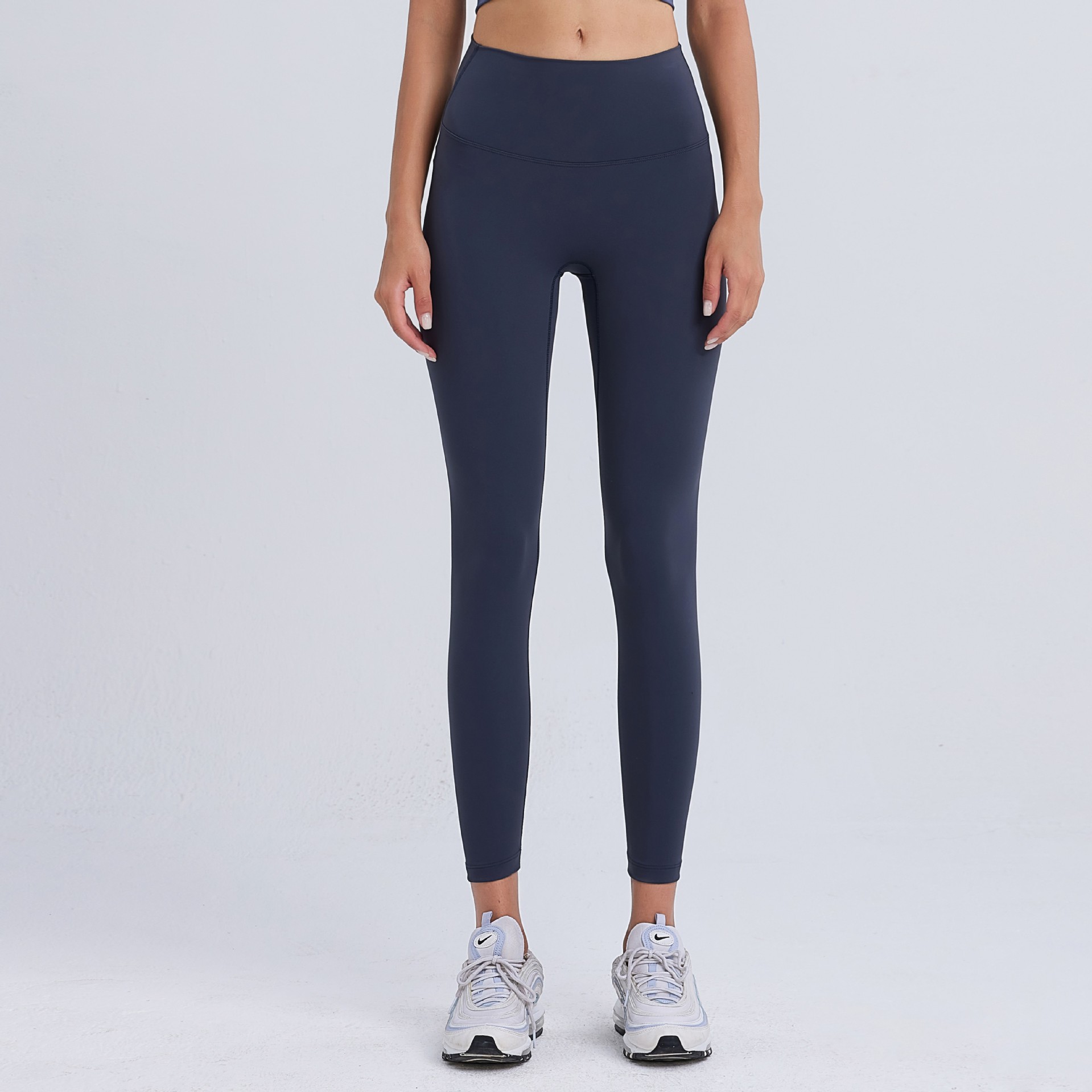 気まずい線の9分のズボンの高弾力のヨガのズボンのレギンスの女性の美のヒップのズボンのやせている腰はやせている運動のタイツを現します