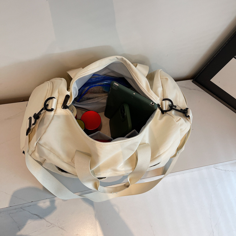 Nueva bolsa de viaje portátil simple y versátil, bolsa de equipaje de gran capacidad para mujeres, bolsa deportiva leve y casual de alta calidad.