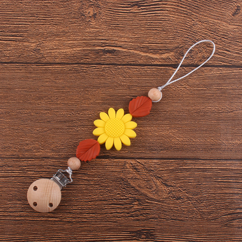 Nuevos suministros para bebés clip de chupete de haya calmante bebé girasol mordedura de silicona chupete cadena anti-caída de la cadena