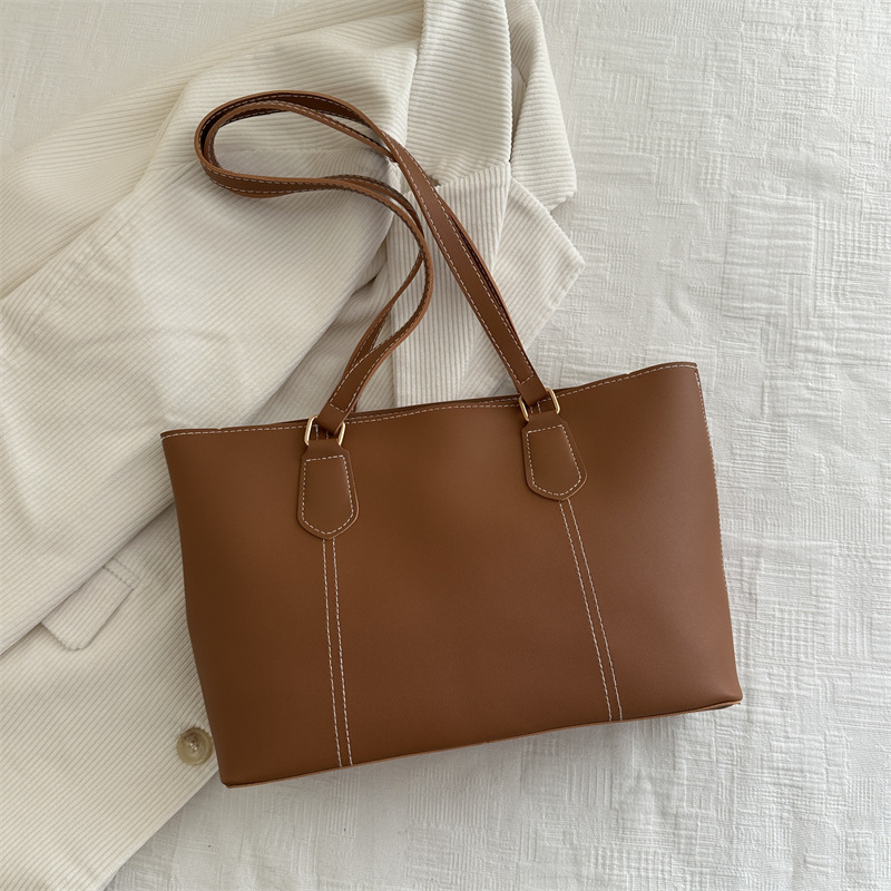 Bolso de viaje de alta gama retro 2025 primavera nuevo estilo salvaje ins color sólido bolso de hombro de trabajo bolso Tote
