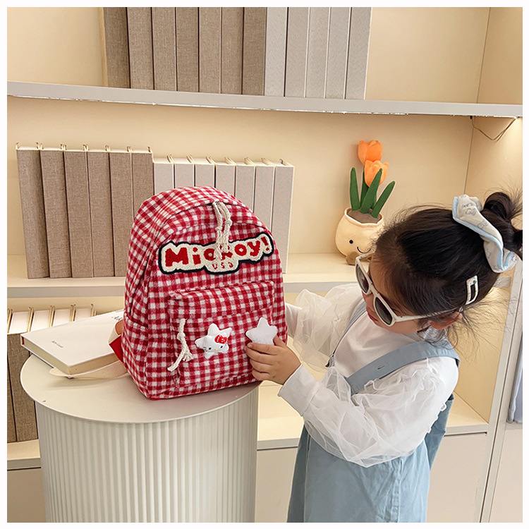 The large-capacity red woolen checkered backpack for primary and secondary school students is a unique and versatile choice. It's a trend for girls to carry backpacks during their leisure trips undefined