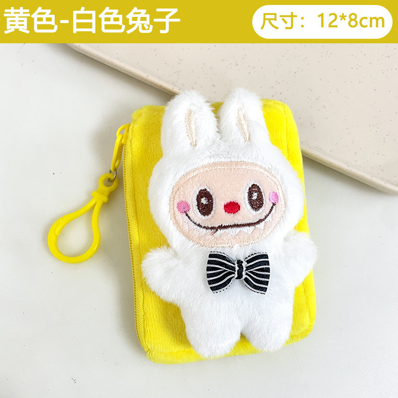 震え音の赤い本が爆発してかわいいぬいぐるみの布の小銭入れのキーホルダーのイヤホンのかばんにプレゼントを掛けます。|undefined