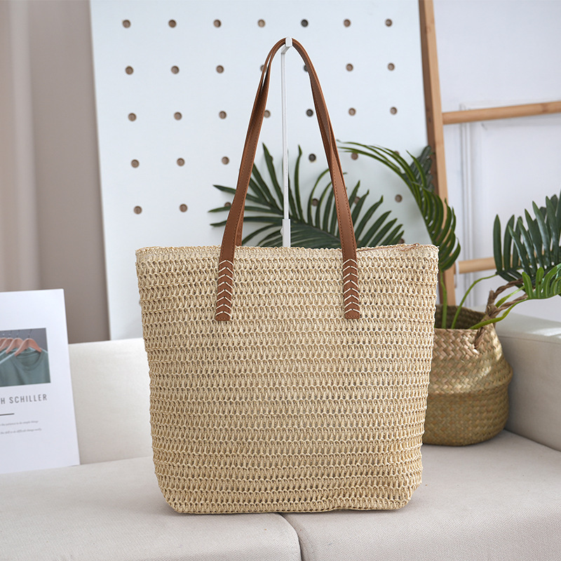Bolsa de paja estilo de vacaciones bolsa tejida de verano modelo femenino 2025 de gran capacidad para ir al trabajo y a la escuela bolsa de viaje al por mayor