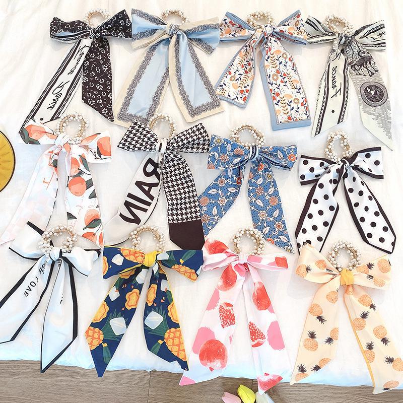 Banda de pelo de bufanda de seda corbata de pelo femenina Shixi Cinta de lazo de perla sale todo partido cuerda de cabeza Shixi 2021 cabello nuevo