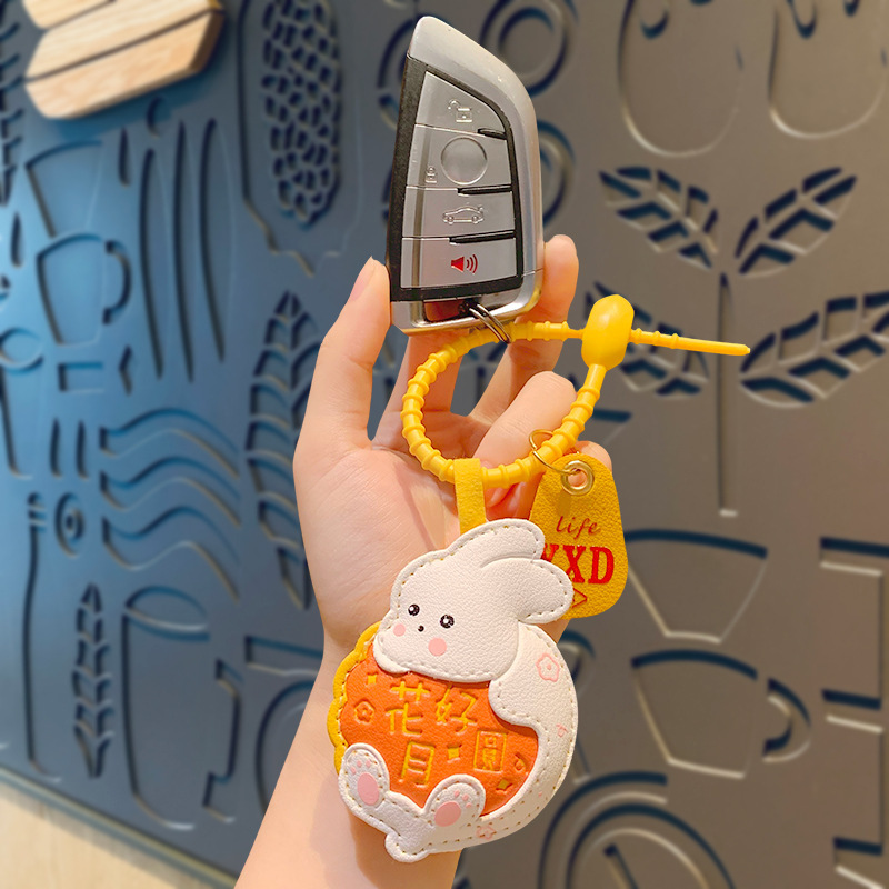 創意的な漫画の革のウサギのキーホルダーはかわいい子供の学生のカバンを掛けてカップルの小さい贈り物の卸売りを飾ります。|undefined