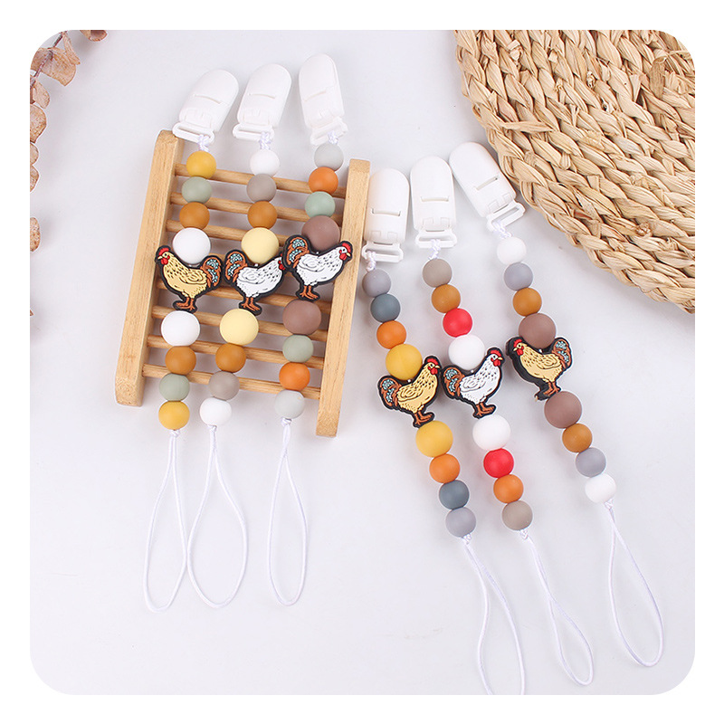 Nuevos bebés y niños series de dibujos animados gallo calmar la cadena de tetas bebés de silicona perlas de goma de dientes de mordida de dientes de mordida de dientes anti-caída cadena