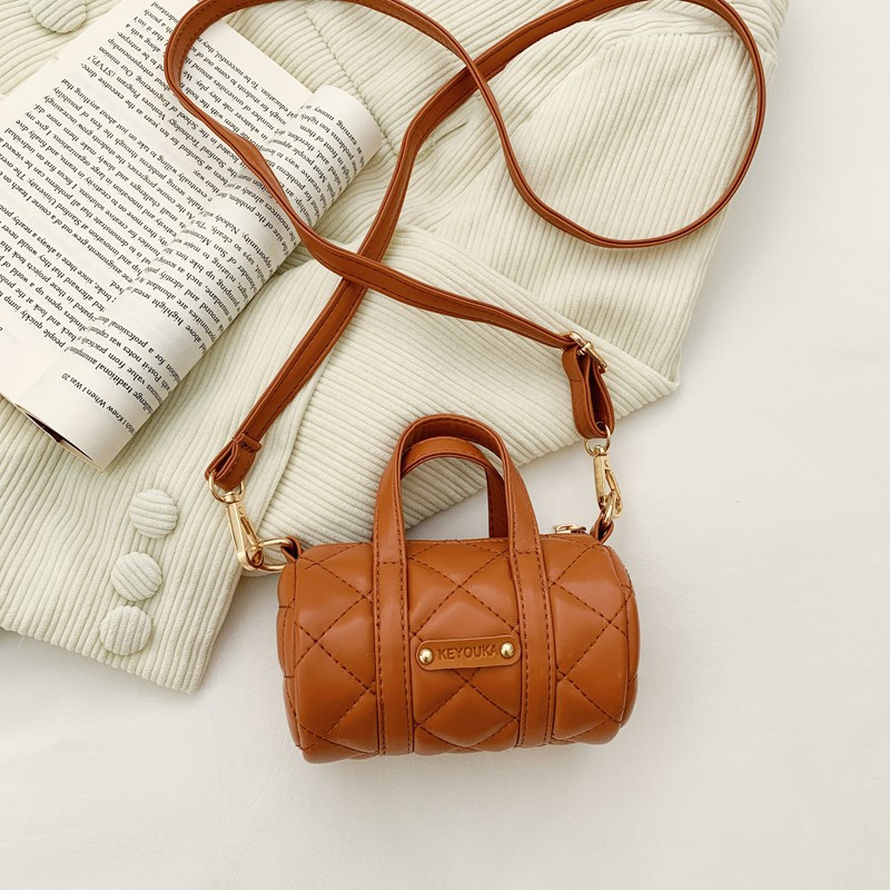 Bolsas infantiles simples de color sólido, bolsas de mini barril de moda coreana, 2025 nuevas bolsas para bebés de comercio exterior