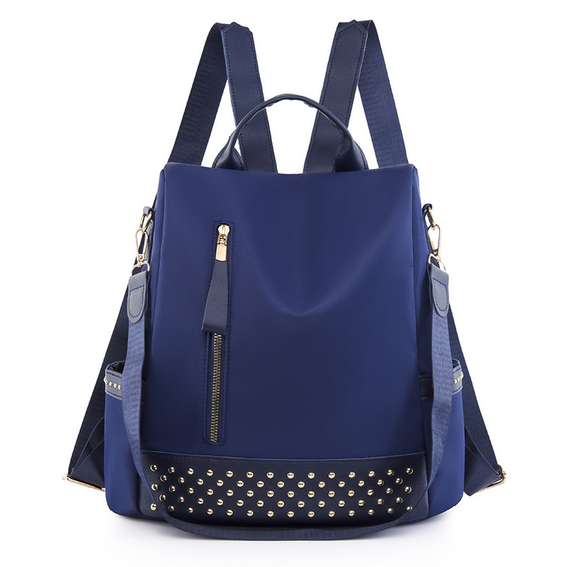 Venta al por mayor 2023 nuevo estilo casual mochila antirrobo mujer simple moda Oxford tela remache mochila escolar de doble uso