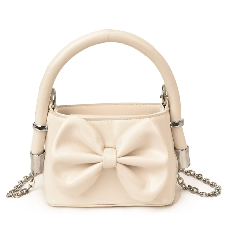Nuevos bolsos de cadena coreanos para niños y niñas, bolsos de mini arco, bolsos de mano para niños, bolsos de comercio exterior transfronterizos