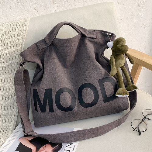 Letter solid color printed canvas large bag style trendy men's canvas shoulder crossbody bag large capacity tote bag can be shipped on behalf of