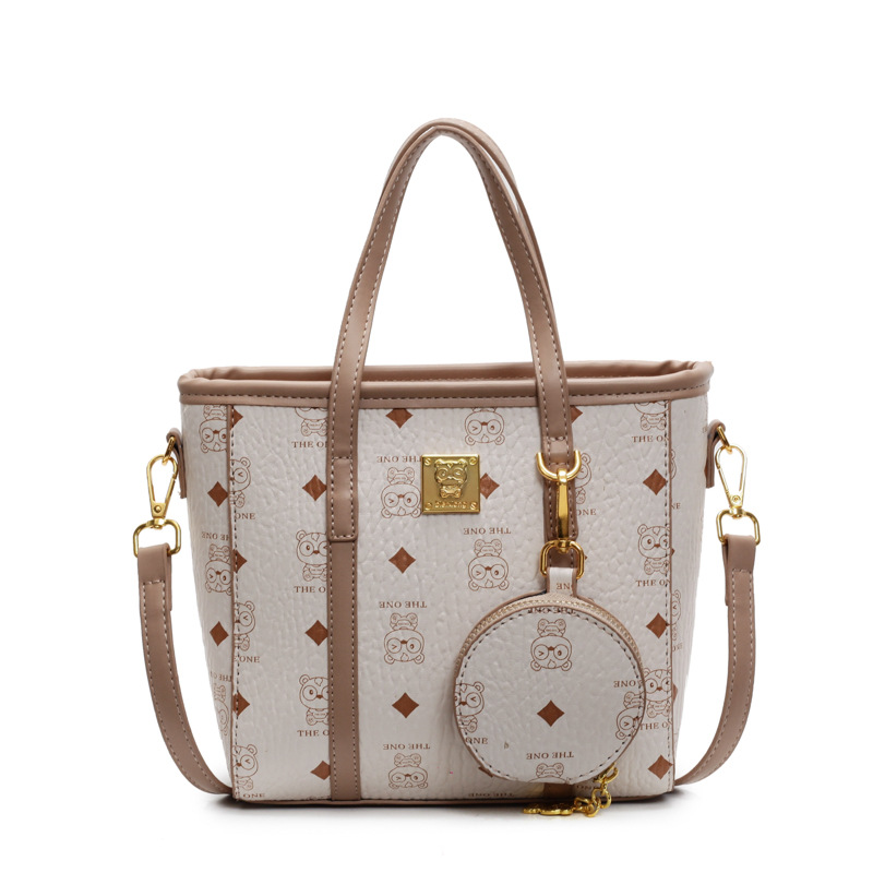 Bolsa de cubo portátil de impresión de moda super caliente para mujeres 2025, nuevo bolso de hombro de nicho universal, bolso de cinturón en línea.