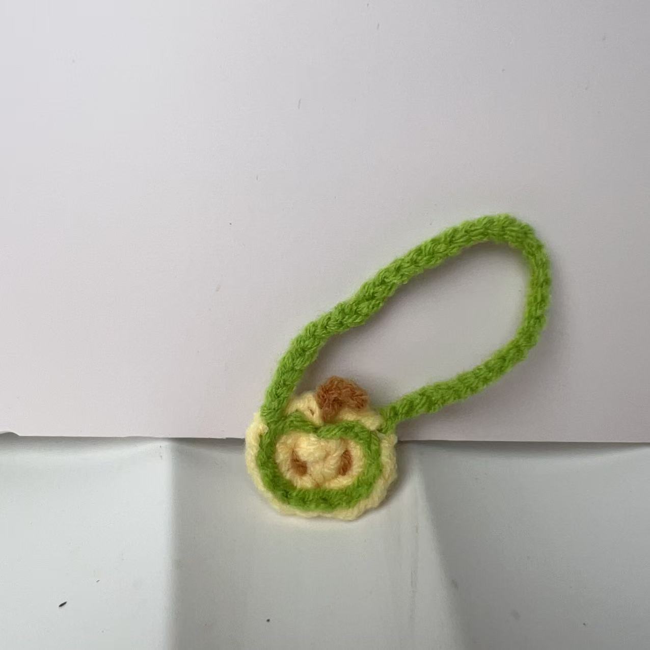 Green apple small hanging diagonally
