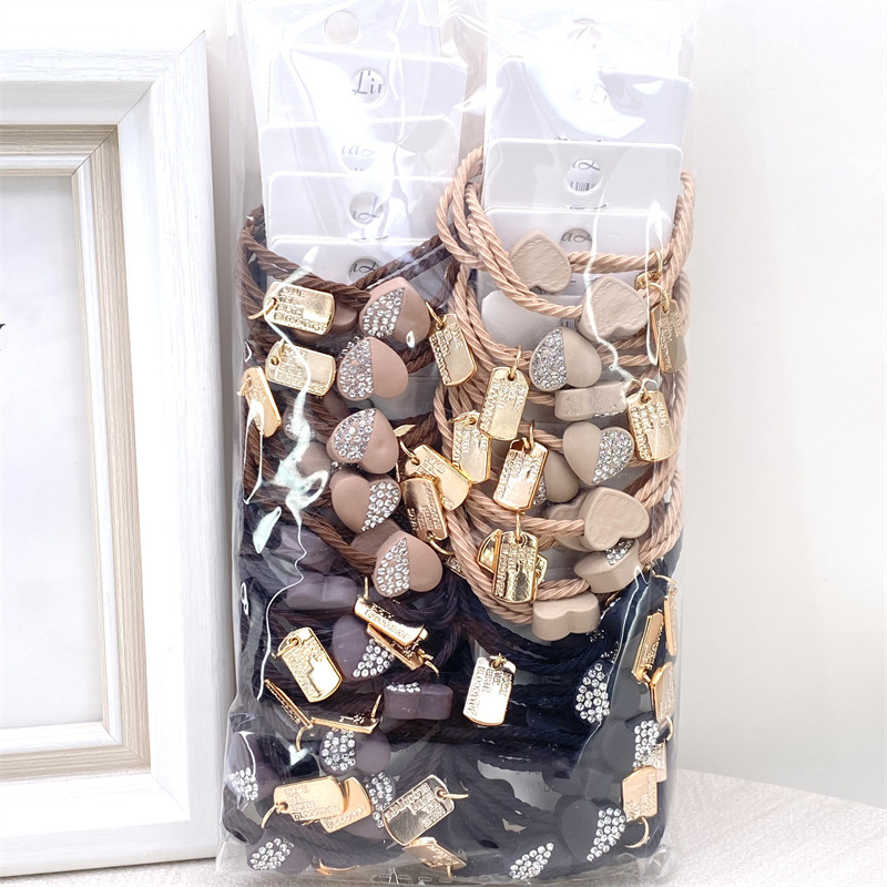 Etiqueta de estilo coreano accesorios para el cabello para niños Perla pequeña pajarita cuerda de pelo chica estudiante cabeza cuerda banda de goma dos yuanes suministro de la tienda