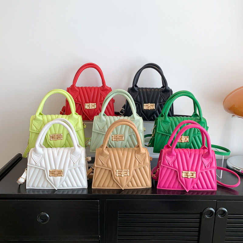 Textura 2025 nueva moda de impresión de estilo extranjero rotary-lock mochila de hombro casual color caramelo bolso de mano de mujer