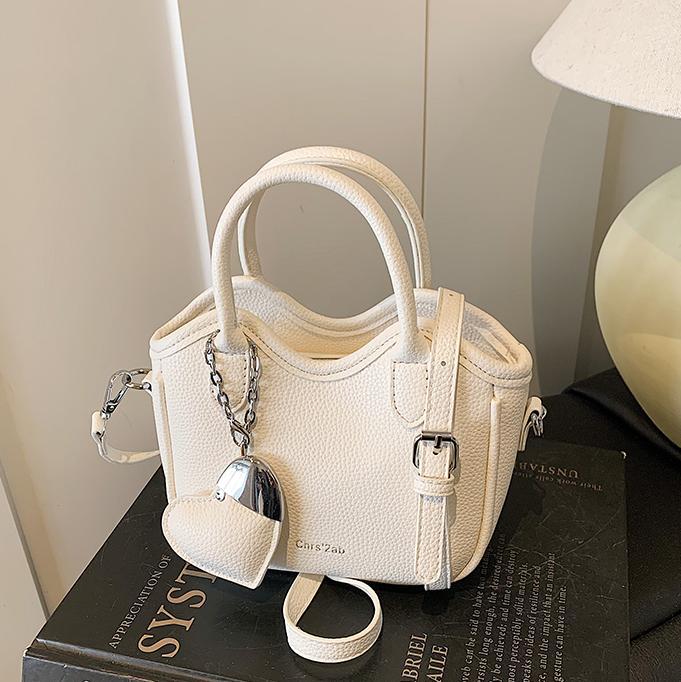 Bolsos pequeños de moda súper calientes de nicho para mujer 2025 nueva tendencia bolsa de cubo de aire extranjero estilo caliente de verano bolso de hombro de mano