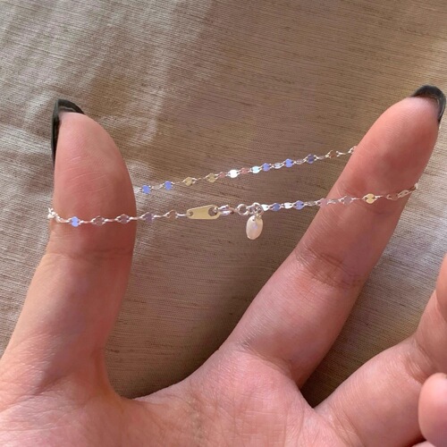 Lustrous wave-like pearl pendant necklace for women, featuring small, exquisite design with a high-end, gentle, and elegant style, suitable for various occasions, crafted with fine rice pearls.
