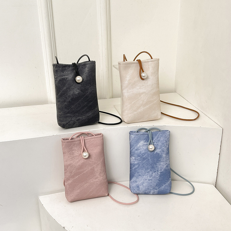 Teléfonos móviles de nicho de alta gama en primavera y verano con bolsos pequeños para mujeres 2025 nueva billetera de cuero blanco simple de un solo hombro