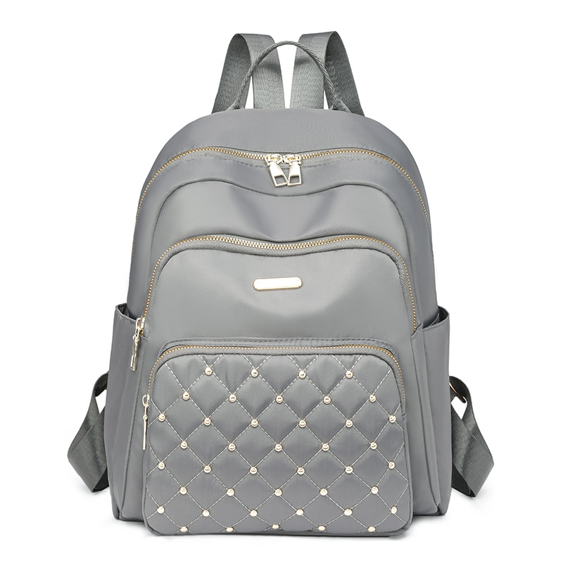 Comercio exterior al por mayor 2024 nuevo estilo casual señoras Lingge mochila moda remache color contraste mochila ligera mochila escolar marea