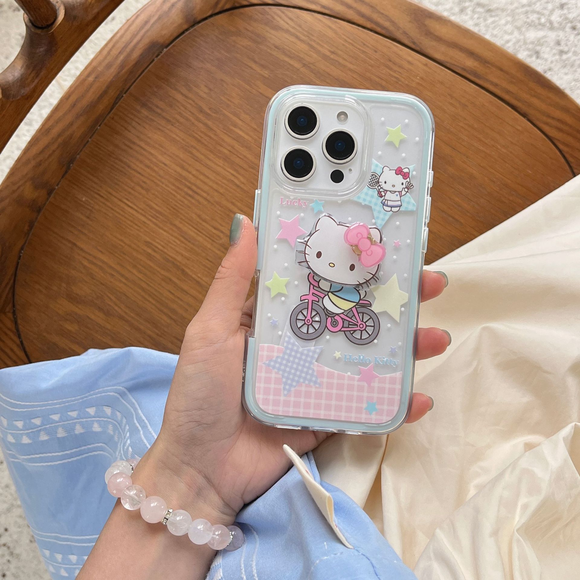 Lindo paseo en bicicleta de dibujos animados KT gato para Apple 15/16 funda para teléfono móvil 14ProMax dos en uno 16Pro femenino 16PM