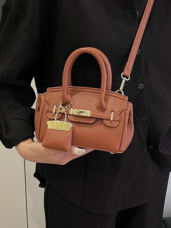 Bolso Kelly de moda coreana para mujer, nuevo modelo transfronterizo de gran venta con textura de alta calidad y diseño de lichi, bolso de hombro y bandolera.