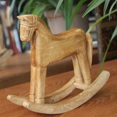 Hand-carved wooden horse from natural wood, pine wood rocking horse with a nostalgic and retro country-style American rural decoration, a rocking horse