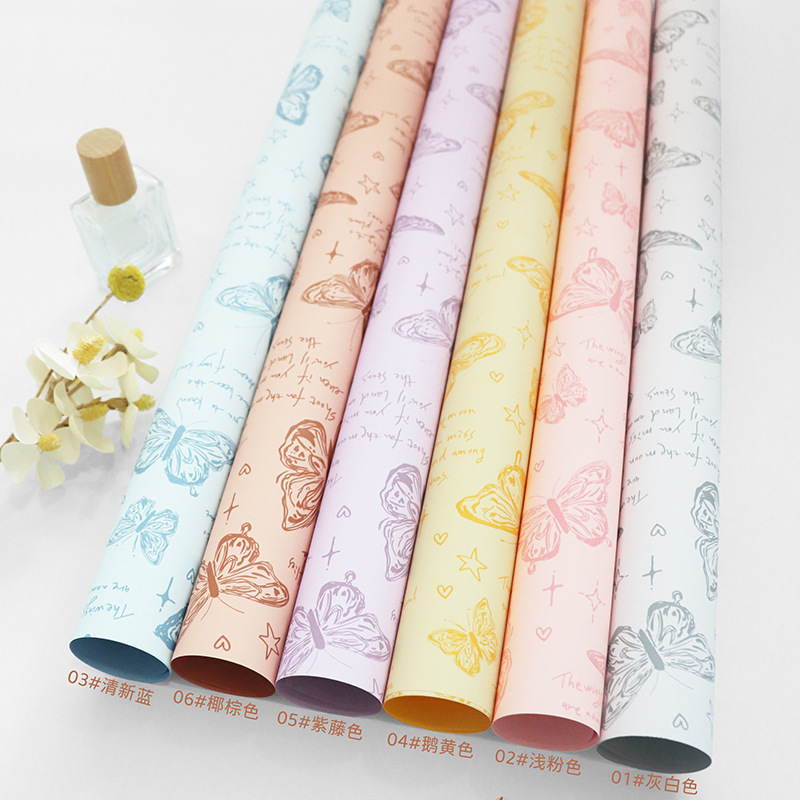 Fabricante de fiestas de flores al por mayor nuevo producto estampado de mariposas papel de embalaje de flores floristería transfronteriza paquete de ramo paquete de papel papel de flores